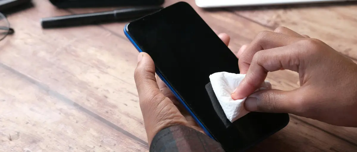 A person cleaning their smartphone