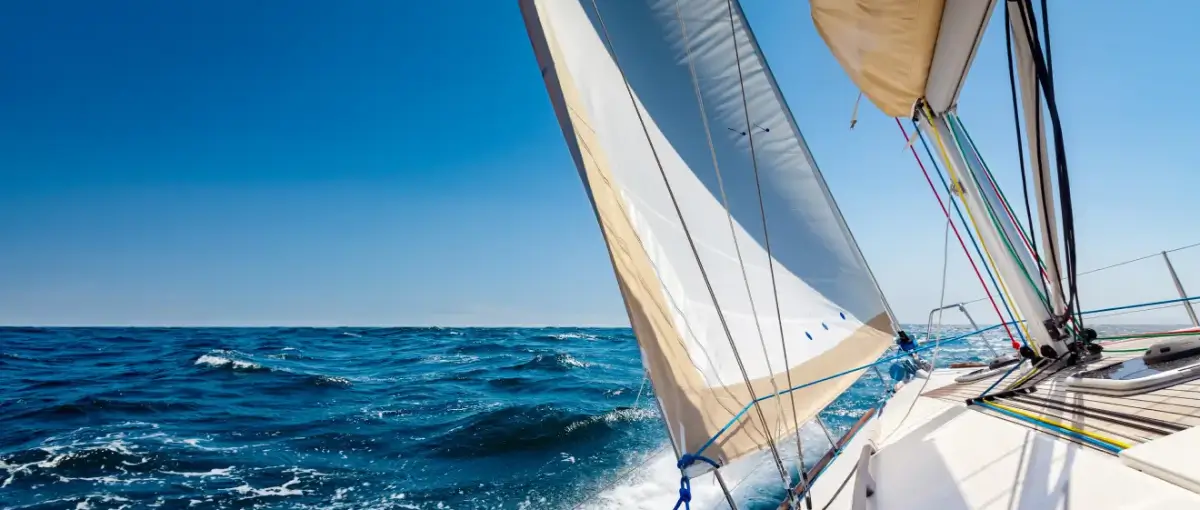 white sailboat in ocean water