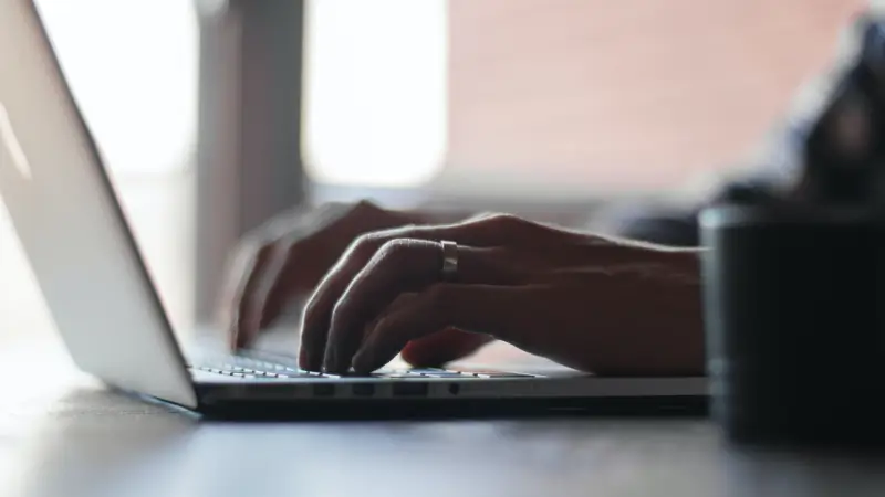 A person is typing on a laptop.