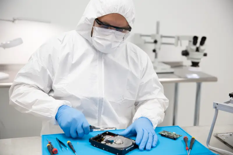An image of a data recovery engineer preparing to retrieve files from a failed hard drive. 