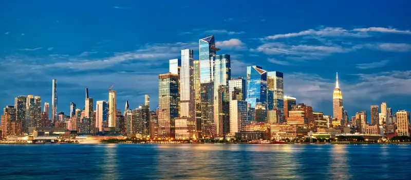 A panorama of the Hudson Yards skyscrapers in Midtown Manhattan at dusk.